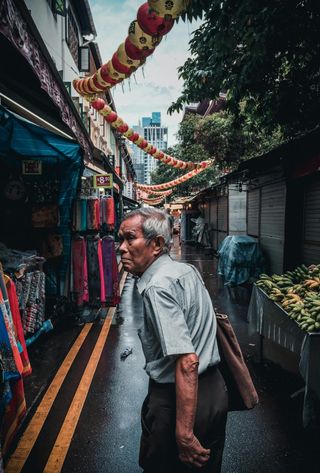 Travel in Asia - Man walking through alleys of Singapore's Chinatown