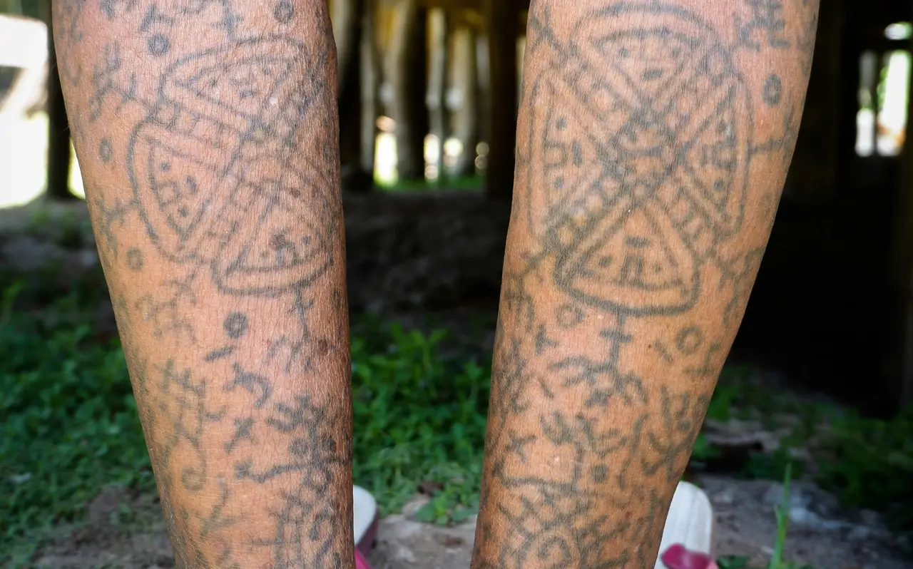 Voyage en Indonésie : Tatouages traditionnels sur les jambes d'un habitant Mentawai